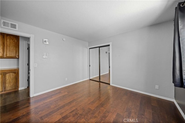 42903 Normandy Ln, Lancaster, CA 93536 - unfurnished bedroom with dark wood-style floors and a closet