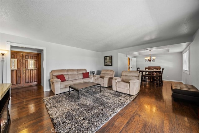 42903 Normandy Ln, Lancaster, CA 93536 - living room with dark wood finished floors, a chandelier, and a textured ceiling