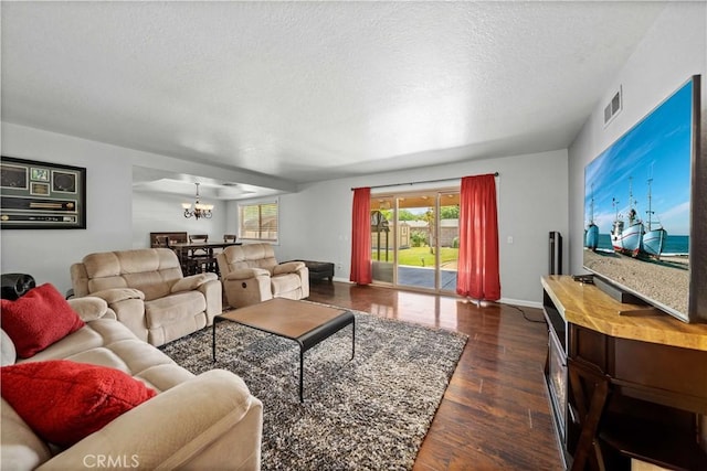 42903 Normandy Ln, Lancaster, CA 93536 - living area with a chandelier, a textured ceiling, healthy amount of natural light, and dark wood-style flooring