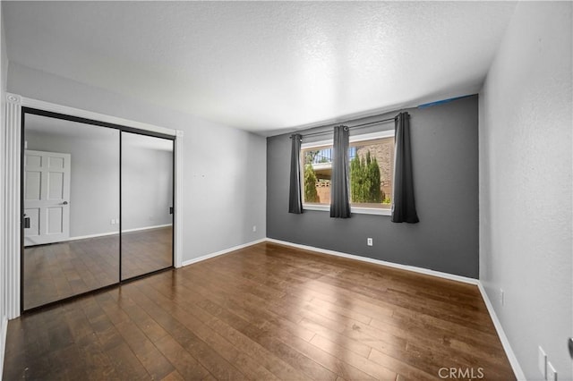42903 Normandy Ln, Lancaster, CA 93536 - unfurnished bedroom featuring hardwood / wood-style floors, a closet, and a textured ceiling