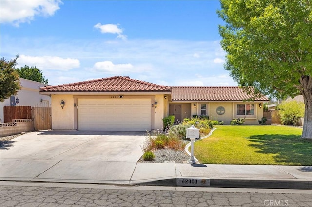 42903 Normandy Ln, Lancaster, CA 93536 - mediterranean / spanish-style house featuring a tiled roof, stucco siding, an attached garage, and concrete driveway