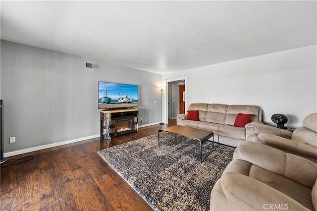 42903 Normandy Ln, Lancaster, CA 93536 - living room with wood finished floors, a lit fireplace, and a textured ceiling