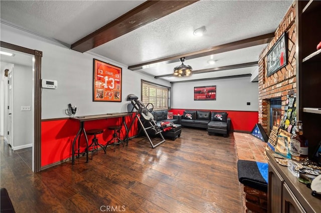 42903 Normandy Ln, Lancaster, CA 93536 - living area featuring a textured ceiling, wood finished floors, beam ceiling, a dry bar, and a brick fireplace