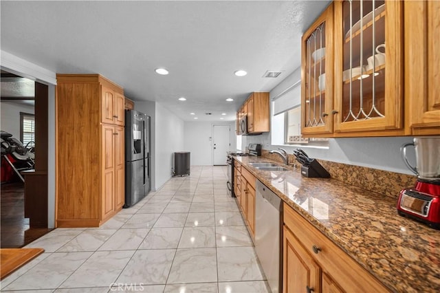 42903 Normandy Ln, Lancaster, CA 93536 - kitchen featuring appliances with stainless steel finishes, plenty of natural light, stone countertops, glass insert cabinets, and recessed lighting