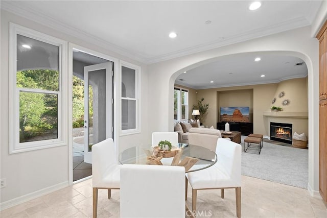 2 Tarascon, Newport Coast, CA 92657 - dining space featuring arched walkways, recessed lighting, a warm lit fireplace, and crown molding