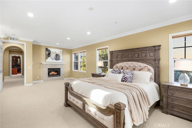 2 Tarascon, Newport Coast, CA 92657 - bedroom featuring recessed lighting, light colored carpet, ornamental molding, a fireplace, and arched walkways