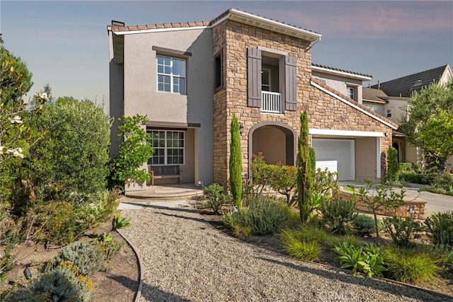 2 Tarascon, Newport Coast, CA 92657 - view of front of home featuring stucco siding, stone siding, and driveway