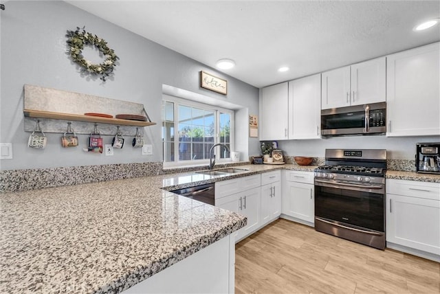 1232 Palos Verde Dr, Corona, CA 92878 - kitchen featuring appliances with stainless steel finishes, white cabinets, light wood-style floors, light stone counters, and recessed lighting