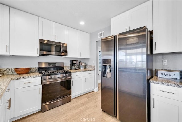 1232 Palos Verde Dr, Corona, CA 92878 - kitchen with appliances with stainless steel finishes, light wood finished floors, white cabinets, light stone countertops, and recessed lighting