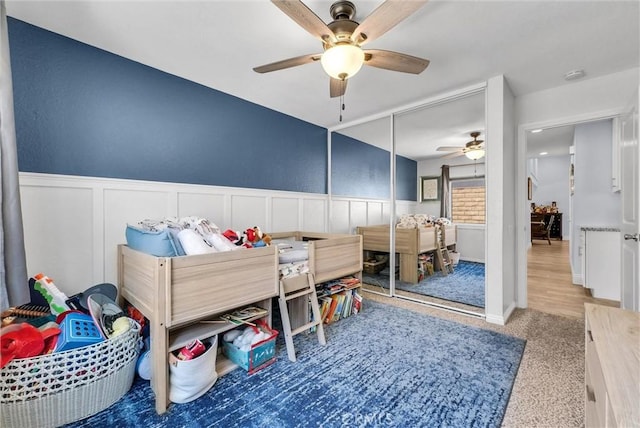 1232 Palos Verde Dr, Corona, CA 92878 - bedroom featuring a wainscoted wall, a decorative wall, a ceiling fan, a closet, and carpet floors