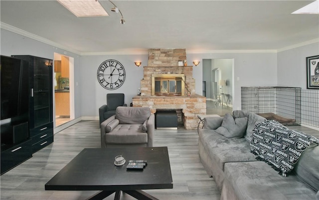 13520 Fenton Ave, Sylmar, CA 91342 - living area featuring a stone fireplace, ornamental molding, and light wood-style floors