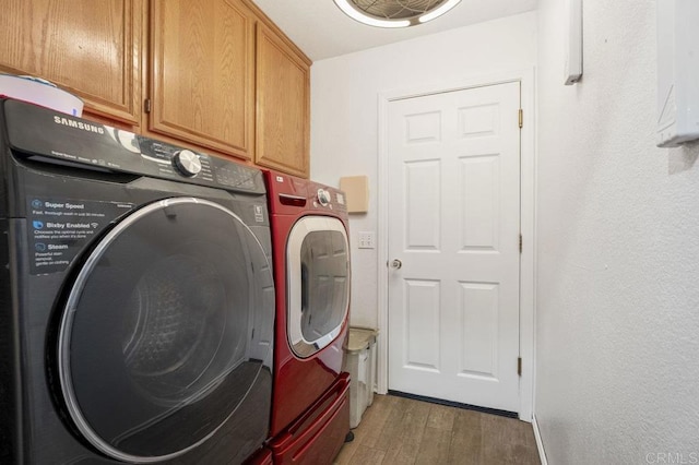 16110 Oak Springs Dr, Ramona, CA 92065 - laundry area featuring washer and dryer, cabinet space, and light wood-type flooring