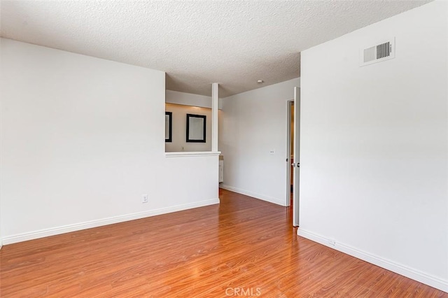 4785 Larwin Ave, Cypress, CA 90630 - spare room with light wood-style flooring and a textured ceiling