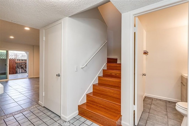 4785 Larwin Ave, Cypress, CA 90630 - stairway featuring a textured ceiling, tile patterned floors, and recessed lighting