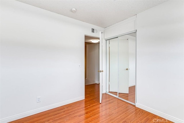 4785 Larwin Ave, Cypress, CA 90630 - unfurnished bedroom with light wood-style floors, a closet, and a textured ceiling