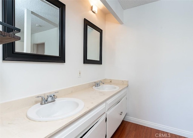 4785 Larwin Ave, Cypress, CA 90630 - bathroom with a textured ceiling, double vanity, and wood finished floors