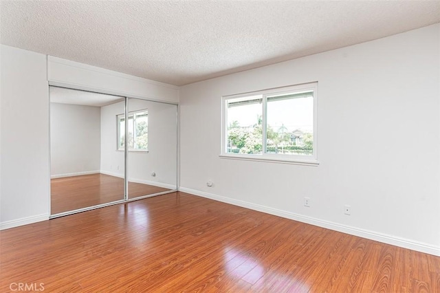 4785 Larwin Ave, Cypress, CA 90630 - unfurnished bedroom with wood finished floors, a textured ceiling, and a closet