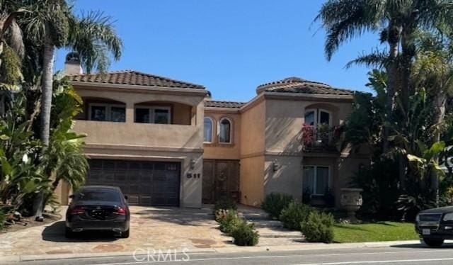 511 Cliff Dr, Newport Beach, CA 92663 - mediterranean / spanish-style home featuring an attached garage, stucco siding, concrete driveway, and a tiled roof