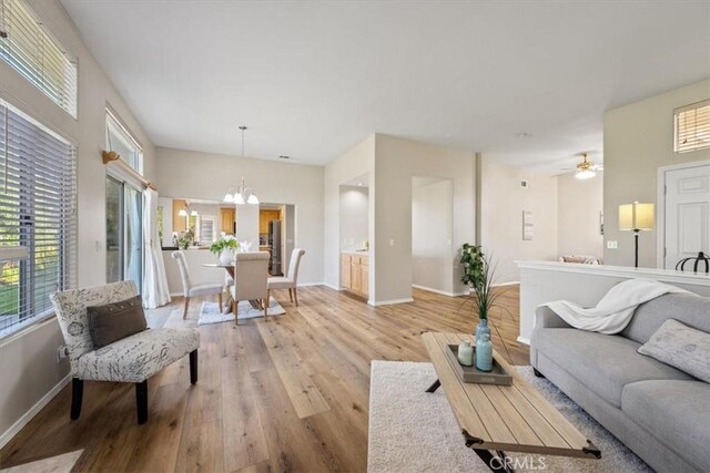 534 Misty View Way, Nipomo, CA 93444 - living area featuring healthy amount of natural light, light wood-style floors, a chandelier, and a ceiling fan