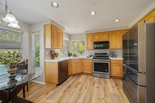 534 Misty View Way, Nipomo, CA 93444 - kitchen with stainless steel appliances, light countertops, light wood-type flooring, decorative light fixtures, and recessed lighting