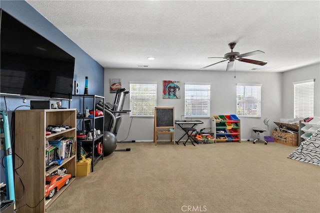 4735 Cassiope Ct, Hemet, CA 92545 - game room with carpet flooring, ceiling fan, plenty of natural light, and a textured ceiling