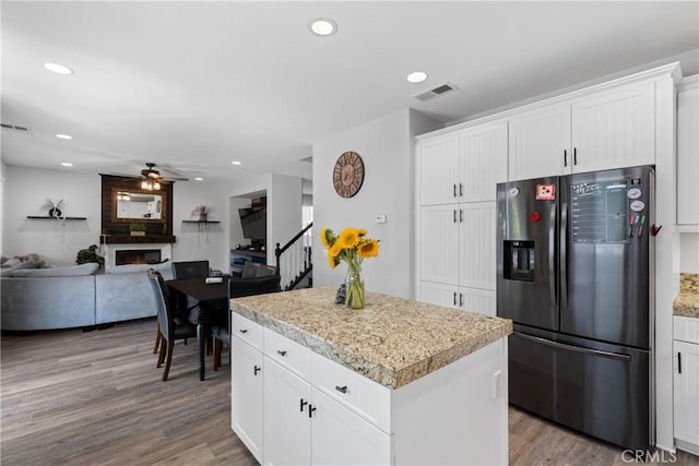 4735 Cassiope Ct, Hemet, CA 92545 - kitchen featuring fridge with ice dispenser, a ceiling fan, a large fireplace, a center island, and open floor plan