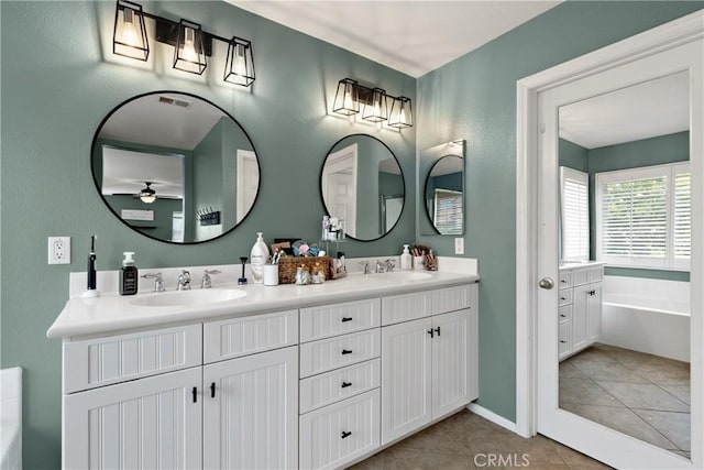 4735 Cassiope Ct, Hemet, CA 92545 - bathroom featuring double vanity, a bath, tile patterned floors, and ceiling fan