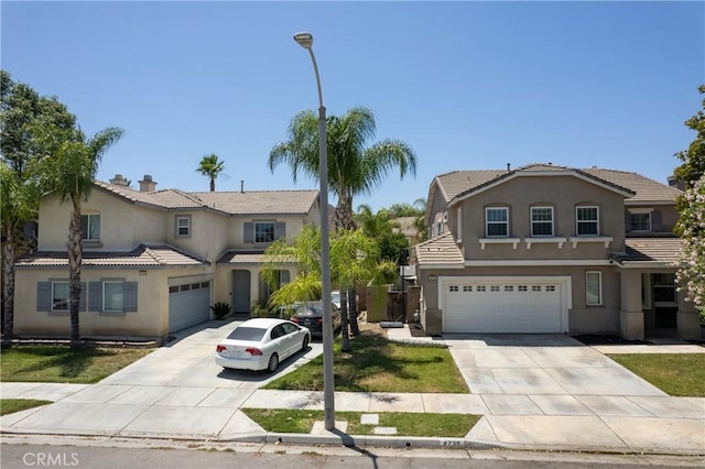 4735 Cassiope Ct, Hemet, CA 92545 - view of front facade with concrete driveway, stucco siding, an attached garage, and a tiled roof