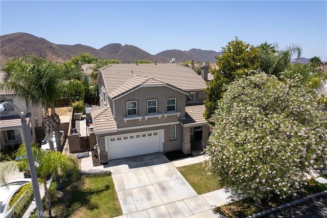 4735 Cassiope Ct, Hemet, CA 92545 - view of front of house featuring driveway, stucco siding, a mountain view, an attached garage, and a tile roof