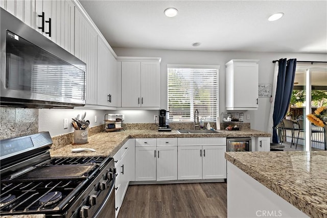 4735 Cassiope Ct, Hemet, CA 92545 - kitchen with gas stove, healthy amount of natural light, white cabinetry, dark wood-style flooring, and recessed lighting