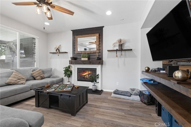 4735 Cassiope Ct, Hemet, CA 92545 - living room with ceiling fan, wood finished floors, a glass covered fireplace, and recessed lighting