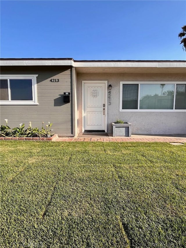 4213 Lonnie St, Oceanside, CA 92056 - property entrance with a yard and stucco siding