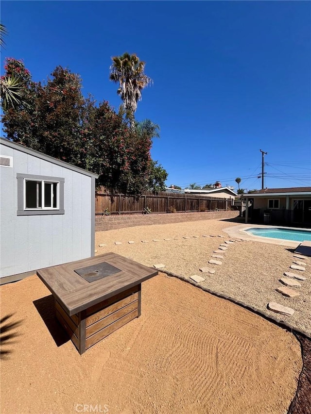 4213 Lonnie St, Oceanside, CA 92056 - fenced backyard featuring a patio area and a storage unit