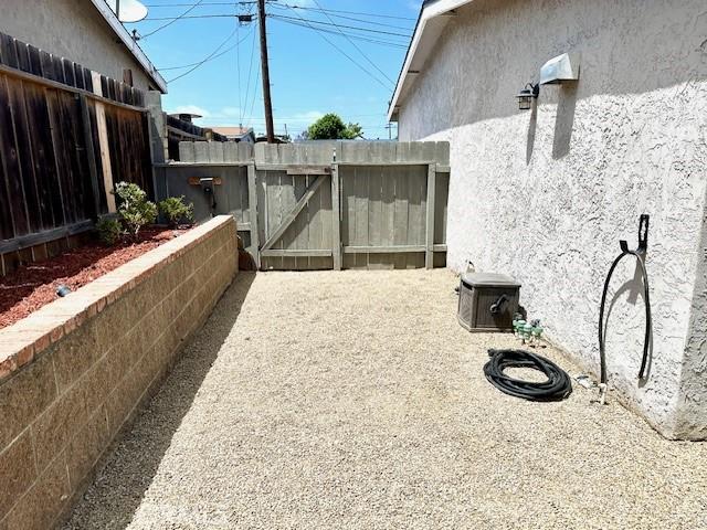 4213 Lonnie St, Oceanside, CA 92056 - view of side of home with stucco siding and a gate