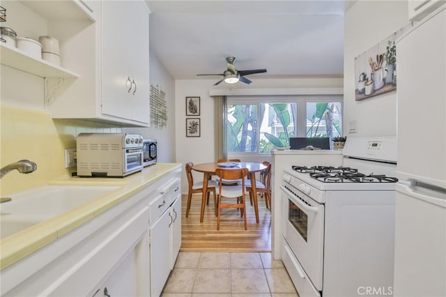 1030 E 2nd St Unit 7, Long Beach, CA 90802 - kitchen with white appliances, white cabinetry, light countertops, a ceiling fan, and open shelves