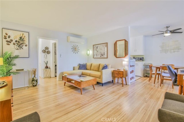 1030 E 2nd St Unit 7, Long Beach, CA 90802 - living room featuring radiator, a wall mounted air conditioner, light wood-type flooring, and a ceiling fan