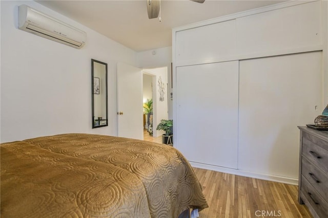 1030 E 2nd St Unit 7, Long Beach, CA 90802 - bedroom with an AC wall unit, light wood-type flooring, a ceiling fan, and a closet