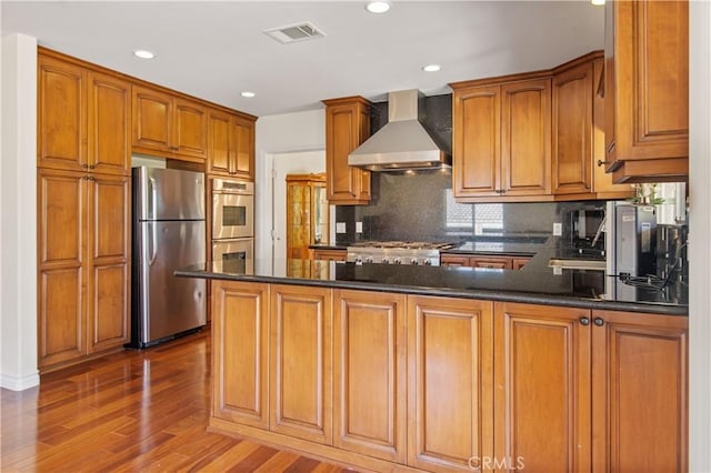 6966 Crest Rd, Rancho Palos Verdes, CA 90275 - kitchen featuring appliances with stainless steel finishes, wall chimney range hood, a peninsula, wood finished floors, and decorative backsplash