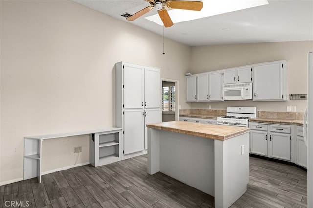 43922 Warner Trl, Palm Desert, CA 92211 - kitchen with white appliances, white cabinetry, ceiling fan, dark wood finished floors, and high vaulted ceiling