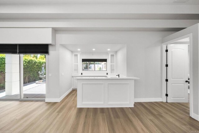 6082 Highland Ave, Yorba Linda, CA 92886 - kitchen with light wood-style floors, white cabinetry, a peninsula, light countertops, and recessed lighting