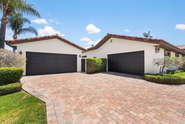 6082 Highland Ave, Yorba Linda, CA 92886 - mediterranean / spanish house with stucco siding, a garage, a tiled roof, and decorative driveway