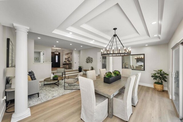 6082 Highland Ave, Yorba Linda, CA 92886 - dining room with a raised ceiling, decorative columns, recessed lighting, light wood-style flooring, and a chandelier