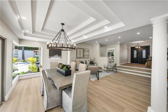 6082 Highland Ave, Yorba Linda, CA 92886 - dining area featuring a tray ceiling, ornamental molding, recessed lighting, decorative columns, and a chandelier