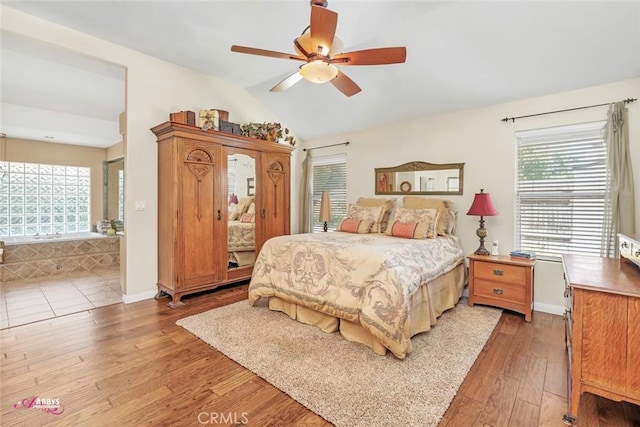 3208 Bridlewood Ct, Bakersfield, CA 93311 - bedroom featuring light wood-style floors, multiple windows, vaulted ceiling, and a ceiling fan
