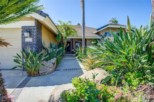 3208 Bridlewood Ct, Bakersfield, CA 93311 - property entrance featuring an attached garage and stucco siding