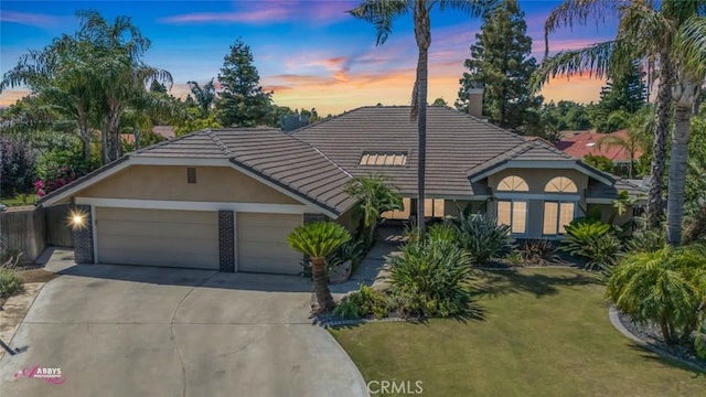 3208 Bridlewood Ct, Bakersfield, CA 93311 - view of front of property featuring concrete driveway, stucco siding, an attached garage, a front lawn, and a tile roof