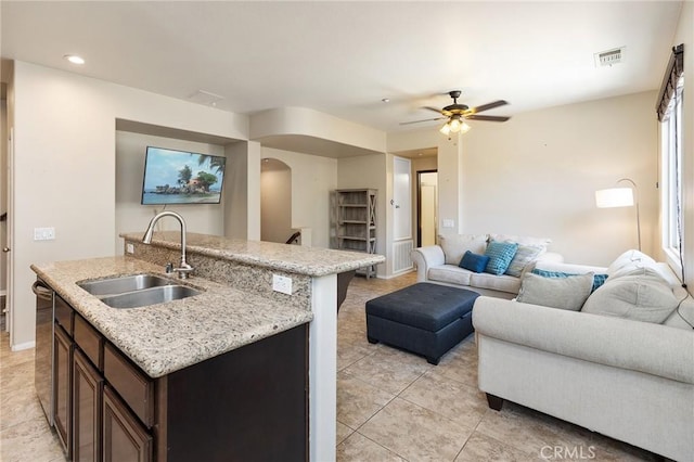 31186 Lavender Ct Unit 164, Temecula, CA 92592 - kitchen featuring arched walkways, open floor plan, dark brown cabinetry, light tile patterned floors, and recessed lighting