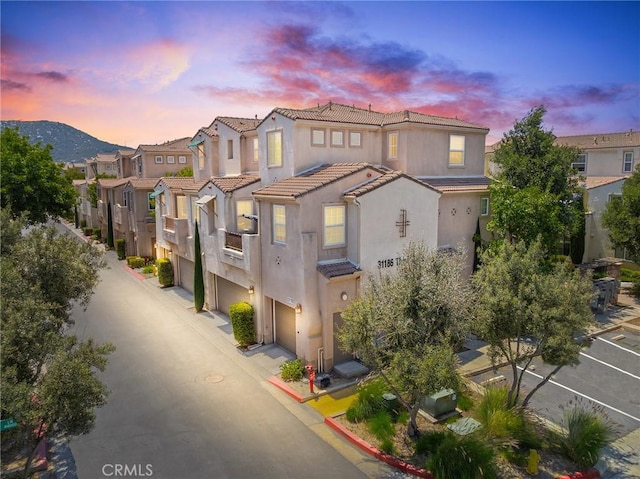 31186 Lavender Ct Unit 164, Temecula, CA 92592 - view of front of house with stucco siding, a tile roof, a garage, and a residential view
