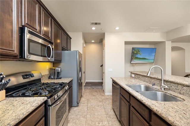 31186 Lavender Ct Unit 164, Temecula, CA 92592 - kitchen featuring stainless steel appliances, dark brown cabinetry, light stone countertops, and recessed lighting