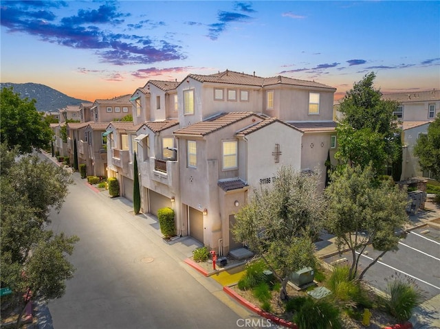 31186 Lavender Ct Unit 164, Temecula, CA 92592 - view of front of home with stucco siding, a tile roof, an attached garage, and a residential view
